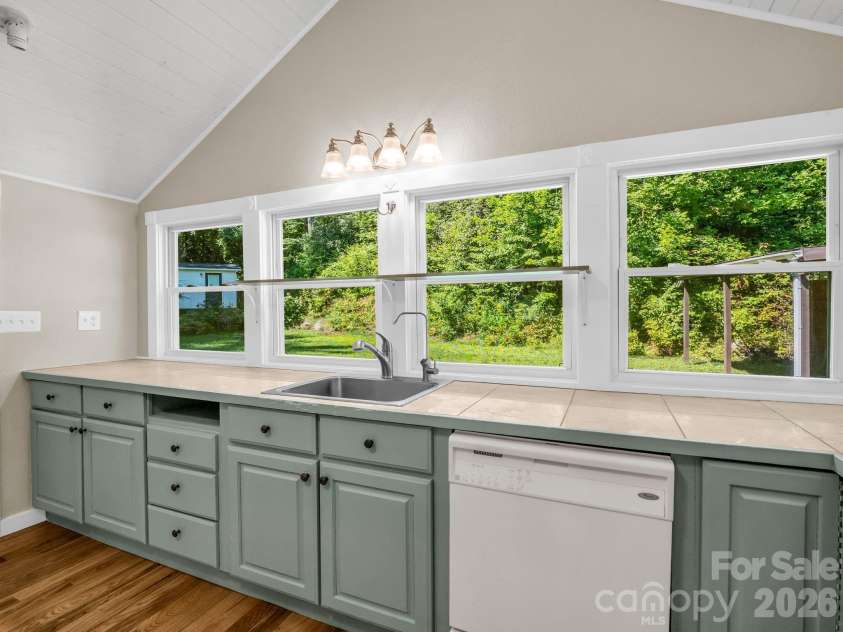 216 Aiken Road, Rosman, NC 28772.  MLS# CAR4401151, YatesRealty ID 36839. Kitchen looking into back yard