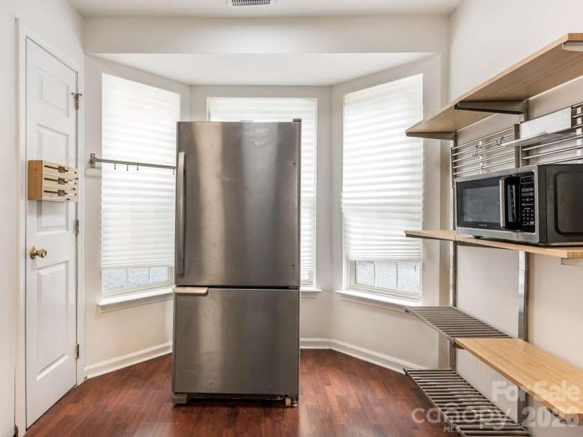 2940 Hosta Drive, Charlotte, NC 28269.  MLS# CAR4398413, YatesRealty ID 36862. Stainless range, refrigerator, microwave, and disposal handle real household cooking without fuss. Equipment that works straightforwardly.
