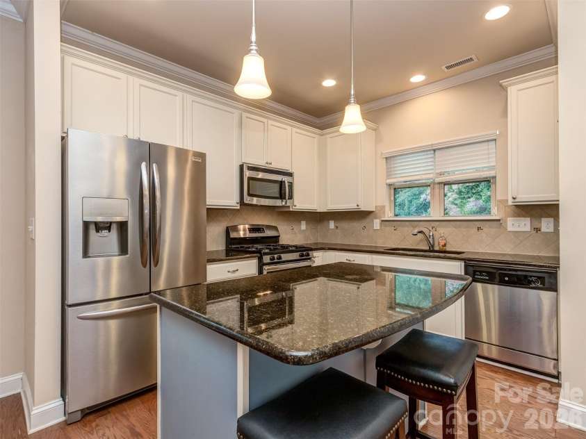 111 Coral Lane, Mooresville, NC 28117.  MLS# CAR4401670, YatesRealty ID 36873. Gourmet Kitchen with Granite Countertops, Island, Stainless Appliances, Tile Backsplash, Recessed & Pendant Lighting, & a Water Heater Recirculating Pump that Provides Hot Water on Demand!