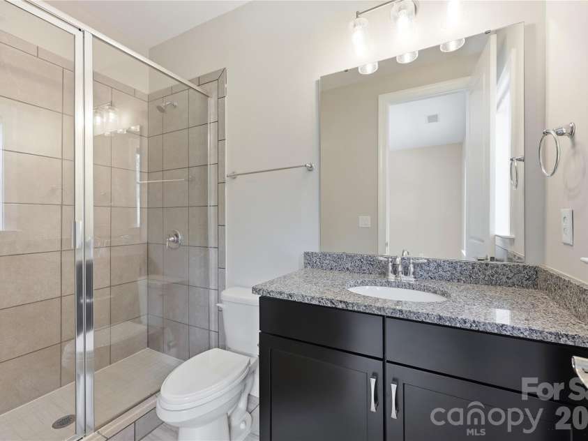 18314 Doves Crest Road, Cornelius, NC 28031.  MLS# CAR4397375, YatesRealty ID 36956. En-suite bathroom with tile walk in shower