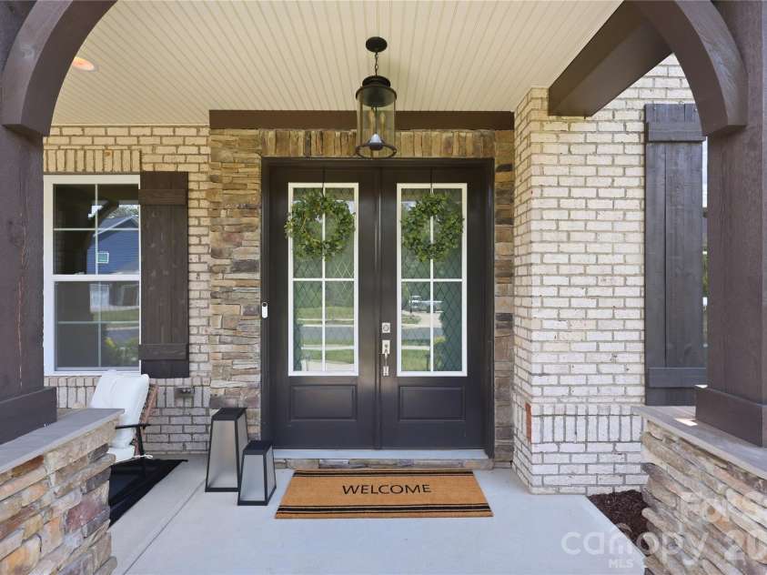 18314 Doves Crest Road, Cornelius, NC 28031.  MLS# CAR4397375, YatesRealty ID 36956. Front entry with wood beam accents