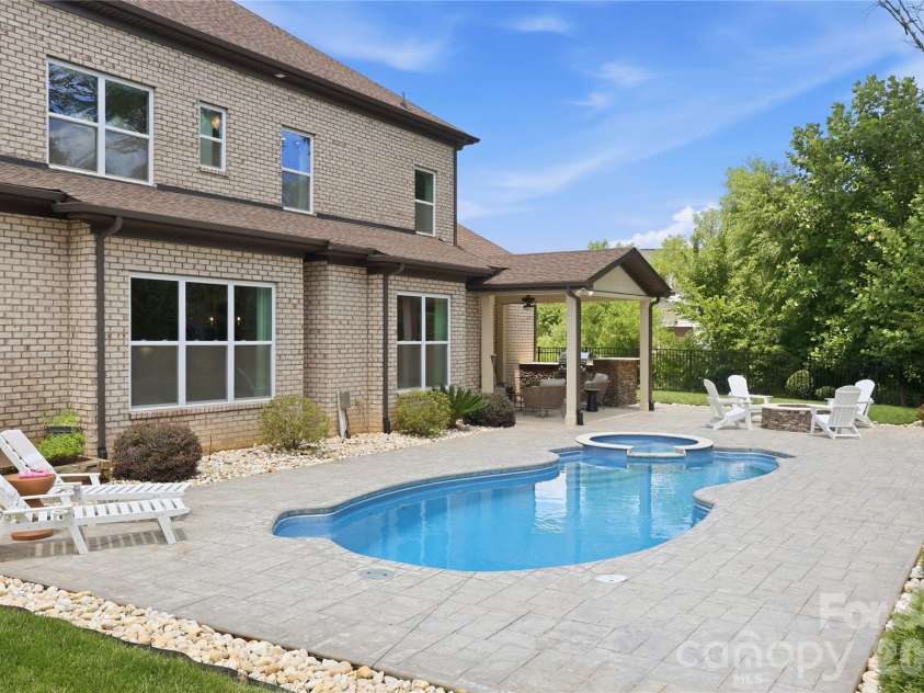 18314 Doves Crest Road, Cornelius, NC 28031.  MLS# CAR4397375, YatesRealty ID 36956. Saltwater heated pool with spa in tranquil backyard