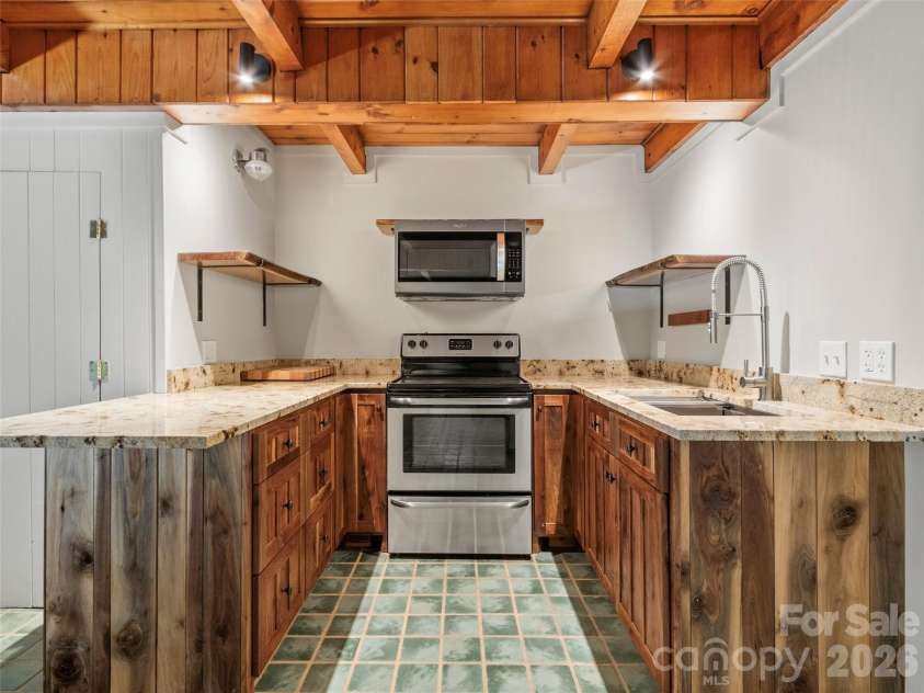 191 Fork Road, Burnsville, NC 28714.  MLS# CAR4355086, YatesRealty ID 37045. Kitchen in main house basement