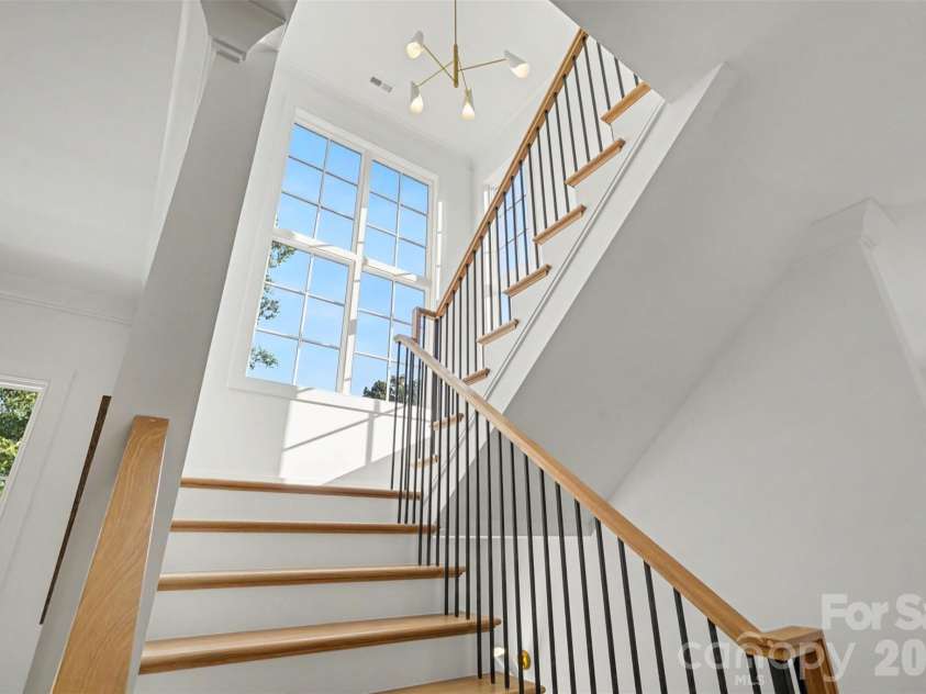 539 Mammoth Oaks Drive, Charlotte, NC 28270.  MLS# CAR4379128, YatesRealty ID 37062. A sun-drenched staircase framed by soaring window