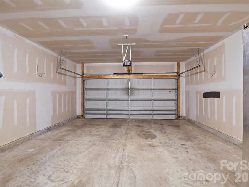 10022 Wrigley Drive, Charlotte, NC 28273.  MLS# CAR4400903, YatesRealty ID 37064. Garage staged virtually empty