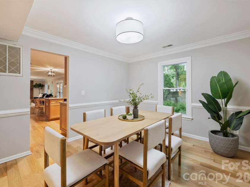 2500 Crescent Knoll Drive, Matthews, NC 28105.  MLS# CAR4399861, YatesRealty ID 37086. An elegant dining room that flows seamlessly into the spacious kitchen.