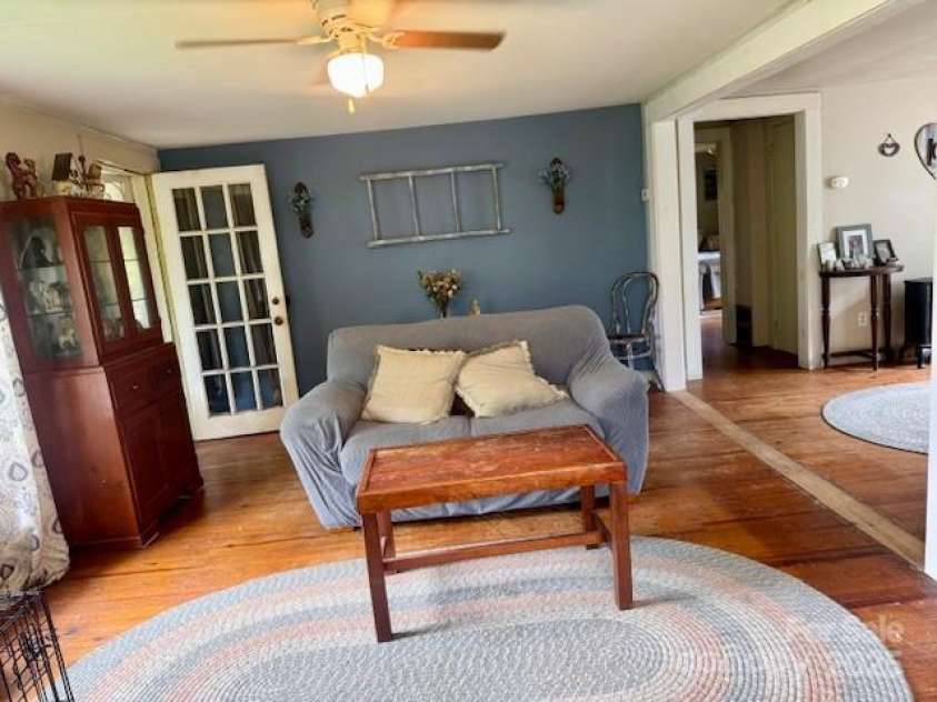 396 & 400 Will Hyatt Road, Waynesville, NC 28786.  MLS# CAR4191538, YatesRealty ID 3709. Freshly painted living room, wood stove