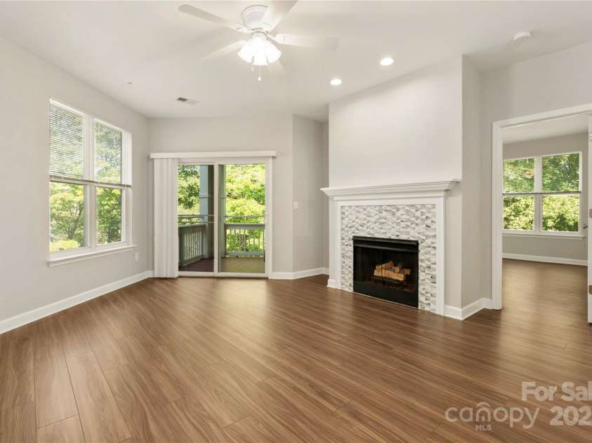 714 Northeast Drive, Davidson, NC 28036.  MLS# CAR4249415, YatesRealty ID 37098. Great room with updated fireplace with gas logs.  Views of Lake Davidson.