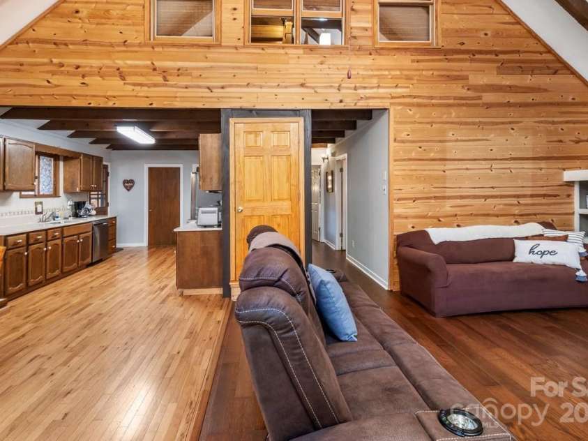 563 Bee Tree Lane, Mars Hill, NC 28754.  MLS# CAR4317356, YatesRealty ID 3714. Kitchen to the left, two bedrooms down the hall on the right.  Door in middle leads upstairs to the primary suite.