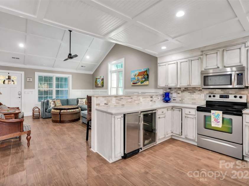 105 37th Street, Oak Island, NC 28465.  MLS# CAR4306548, YatesRealty ID 37250. Kitchen looking into Living Room