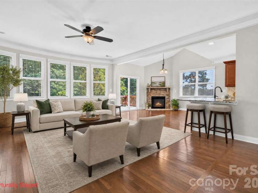 6405 Alba Rose Lane, Huntersville, NC 28078.  MLS# CAR4397325, YatesRealty ID 37262. Virtually staged living room looking into the breakfast nook, complete with gas fireplace