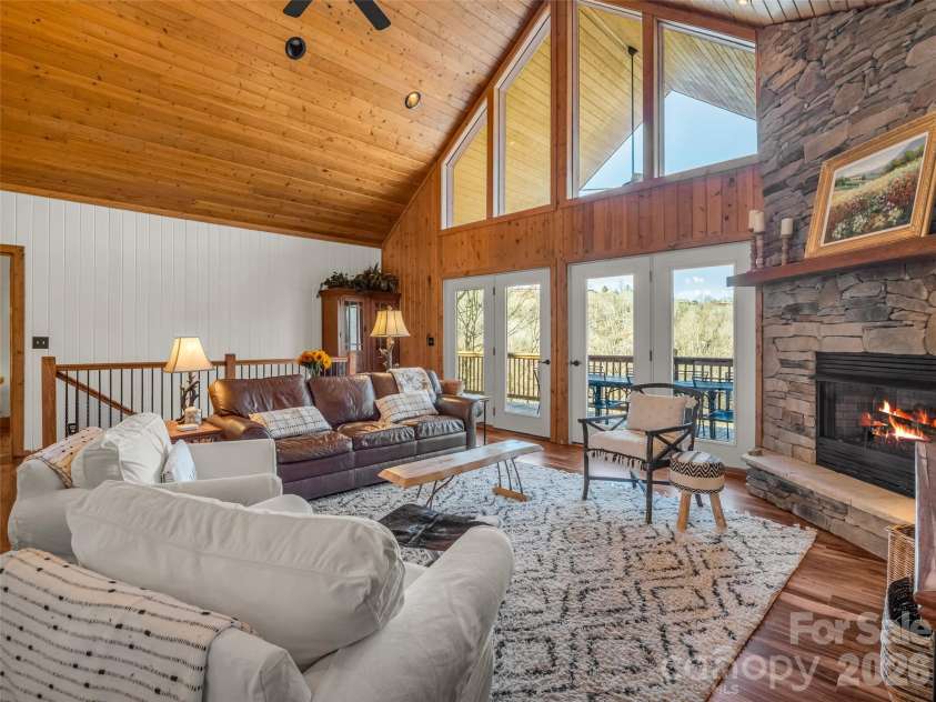 32 Zebulon Lane, Mars Hill, NC 28754.  MLS# CAR4336470, YatesRealty ID 3728. Soaring ceilings not only showcase the stunning fireplace, but also the year round view.