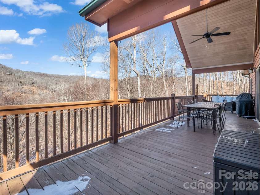 32 Zebulon Lane, Mars Hill, NC 28754.  MLS# CAR4336470, YatesRealty ID 3728. The top deck offers the best of both worlds, featuring a generous covered area for shade and relaxation, along with open uncovered portions for those who want to soak up the sunshine.