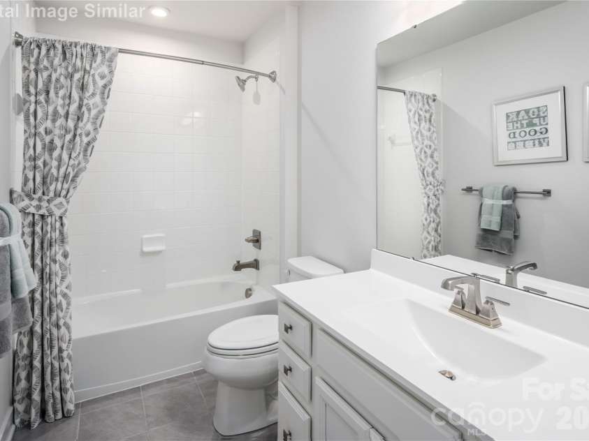 2056 Fernway Drive, Charlotte, NC 28216.  MLS# CAR4345531, YatesRealty ID 37345. Shared bath serenity — relax in the tub and unwind in style