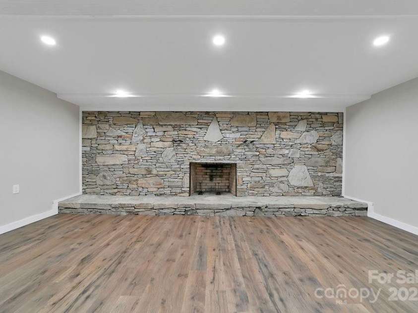 7321 Greenville Highway, Brevard, NC 28712.  MLS# CAR4302860, YatesRealty ID 3738. Massive Stone Fireplace in Basement