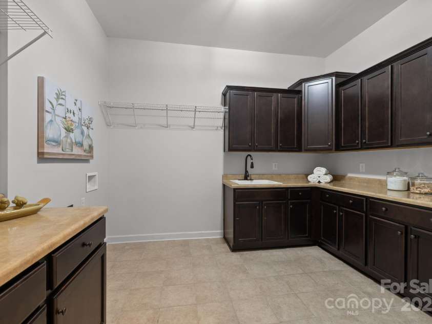 3009 Botetourt Court, Weddington, NC 28104.  MLS# CAR4263826, YatesRealty ID 37389. Laundry room w/sink & cabinetry