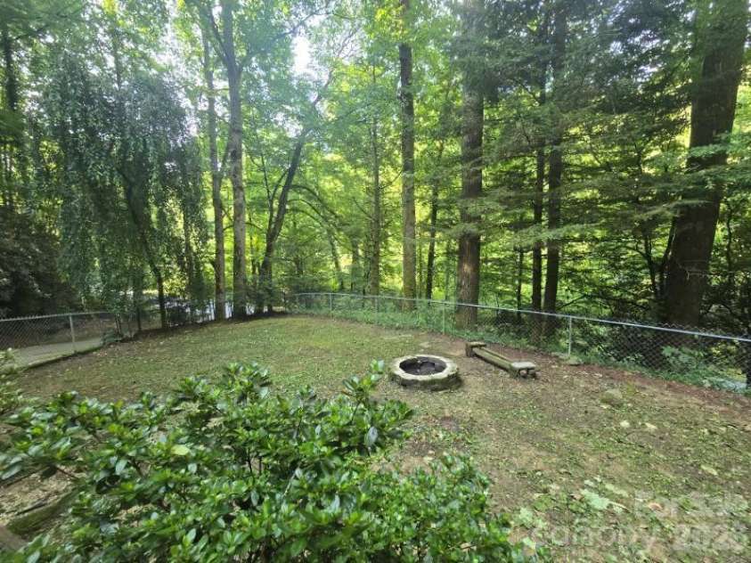 4105 Pickens Highway, Rosman, NC 28772.  MLS# CAR4386563, YatesRealty ID 37389. Fully fenced front yard with firepit and small springs on both sides. Looking out towards the street!