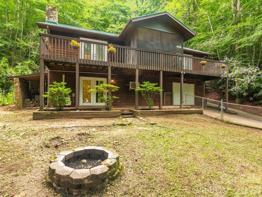 4105 Pickens Highway, Rosman, NC 28772.  MLS# CAR4386563, YatesRealty ID 37389. House and front yard with its front yard firepit.