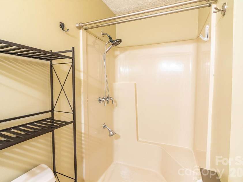 4105 Pickens Highway, Rosman, NC 28772.  MLS# CAR4386563, YatesRealty ID 37389. Primary bedroom has this ensuite bathroom, here looking right.