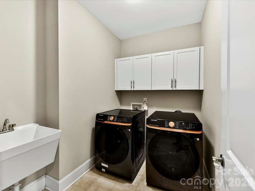 2028 Perry Pond Drive, Waxhaw, NC 28173.  MLS# CAR4383603, YatesRealty ID 37422. Upper level laundry with utility sink and cabinets