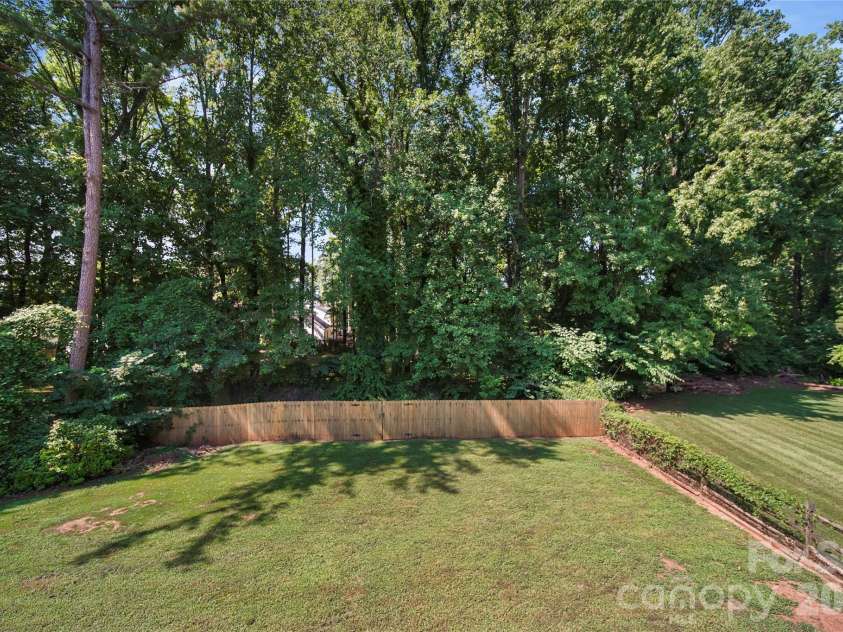 8615 Harmony Bridge Place, Charlotte, NC 28216.  MLS# CAR4381839, YatesRealty ID 37437. Wooded Backyard