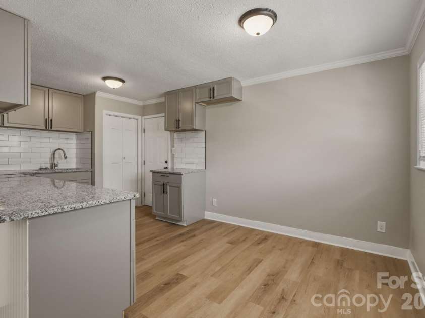 4706 Brooktree Drive, Charlotte, NC 28208.  MLS# CAR4404822, YatesRealty ID 37440. Walking over to the kitchen area. Empty space highlighted on the right is the dining area.