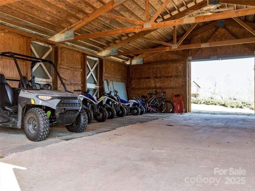 55 Plantation Drive, Asheville, NC 28806.  MLS# CAR4230730, YatesRealty ID 3745. Horse Barn Interior View. Very clean with plenty of space. Water lines in place for 3 individual horse stalls.