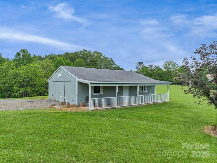 55 Plantation Drive, Asheville, NC 28806.  MLS# CAR4230730, YatesRealty ID 3745. Horse Barn with workshop area. Barn doors on both ends allows for pull through access and great cross breeze.