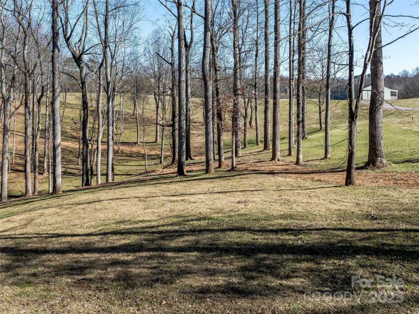 55 Plantation Drive, Asheville, NC 28806.  MLS# CAR4230730, YatesRealty ID 3745. View of grounds, partial trail system and horse barn.