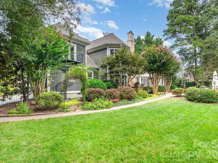 133 Brick Kiln Way, Mooresville, NC 28117.  MLS# CAR4297139, YatesRealty ID 3749. Iron Archway leads to Exterior Spiral Staircase with easy access to the Bar/Rec Room
