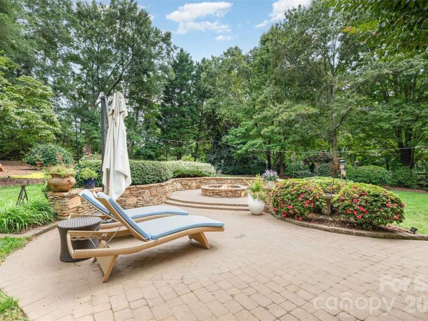 133 Brick Kiln Way, Mooresville, NC 28117.  MLS# CAR4297139, YatesRealty ID 3749. Paver Patio with large Stone firepit with sitting wall is perfect for large gatherings.