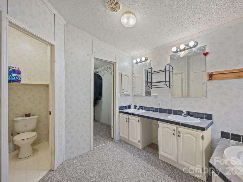 74 Davis Chapel Road, Candler, NC 28715.  MLS# CAR4311937, YatesRealty ID 3750. Primary ensuite bathroom