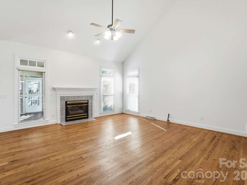 8044 Hawk Crest Court, Charlotte, NC 28270.  MLS# CAR4267919, YatesRealty ID 3752. Vaulted family room- hardwood flooring, ceiling fan- there is a coat closet in this area and opens to kitchen/breakfast area