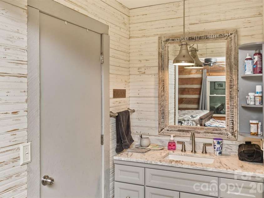 1059 Setzer Cove Road, Maggie Valley, NC 28751.  MLS# CAR4388109, YatesRealty ID 37523. Master Vanity between walk in closet and bath