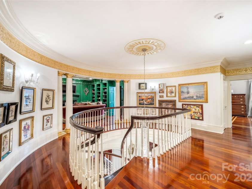 2665 Rolling Hills Drive, Monroe, NC 28110.  MLS# CAR4296531, YatesRealty ID 376. Art lined rotunda with private den/library divides the two suites on the second level.