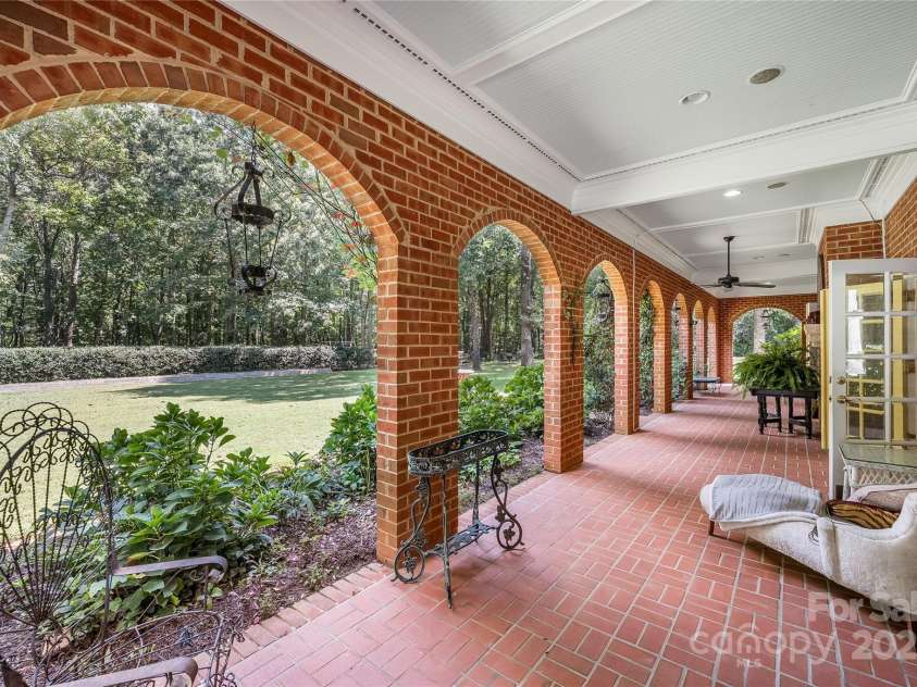 2665 Rolling Hills Drive, Monroe, NC 28110.  MLS# CAR4296531, YatesRealty ID 376. Lower-level covered patio leads you onto the beautifully landscaped yard with raised garden beds, rose bushes and chicken coop.