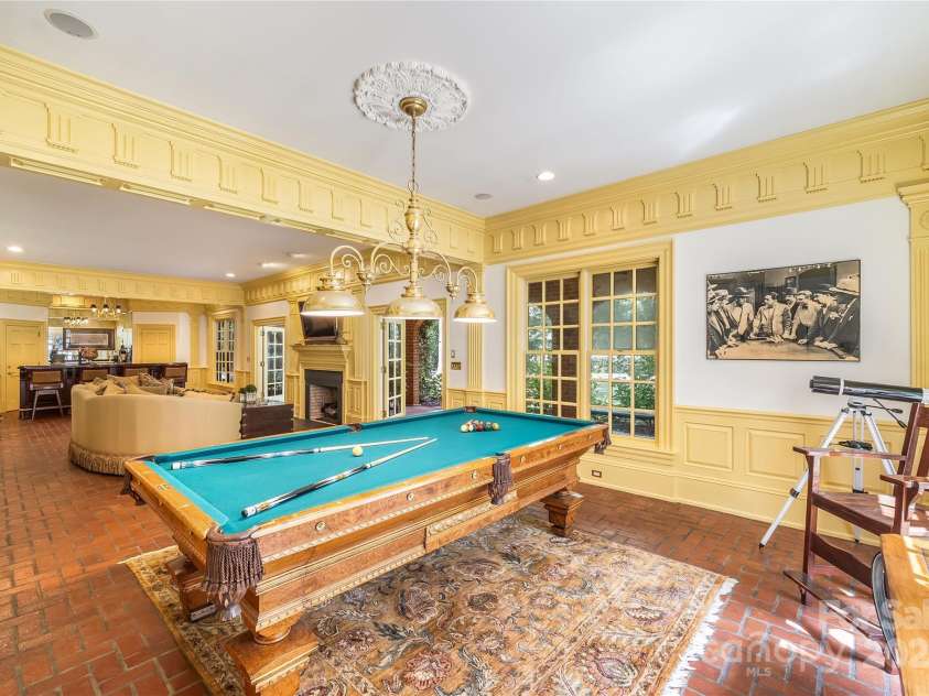 2665 Rolling Hills Drive, Monroe, NC 28110.  MLS# CAR4296531, YatesRealty ID 376. Lower-level family room offers billiards, wet bar, fireplace and the perfect spot to watch the games.  The separate media room has a great movie watching atmosphere.  The media room has also served as a bedroom when ne