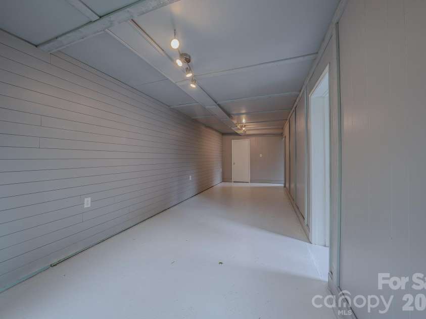 501 Fairview Road, Asheville, NC 28803.  MLS# CAR4393611, YatesRealty ID 37603. Large flex room in basement