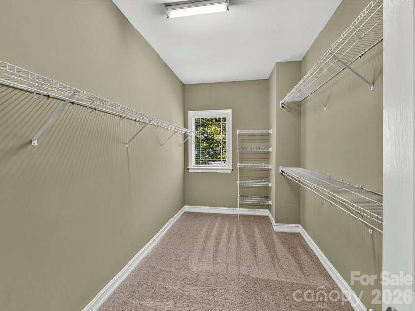 18814 Coachmans Trace, Cornelius, NC 28031.  MLS# CAR4399708, YatesRealty ID 37607. An oversized walk-in closet with built-in shelving and hanging space provides exceptional storage and organization.