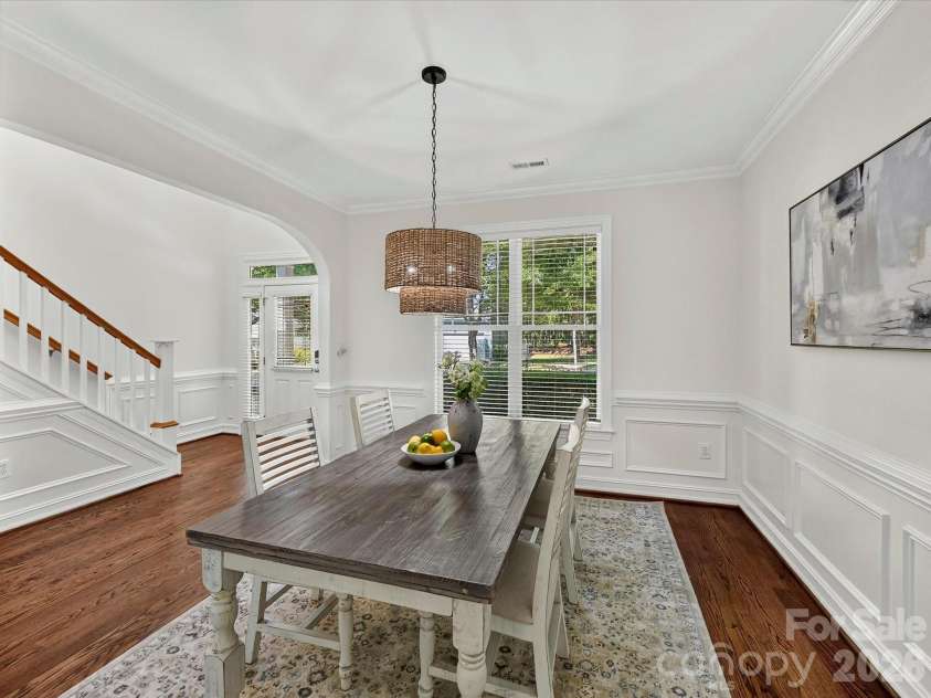 18814 Coachmans Trace, Cornelius, NC 28031.  MLS# CAR4399708, YatesRealty ID 37607. Elegant wainscoting, crown molding, and a designer light fixture create a warm and inviting formal dining room perfect for hosting family and friends.