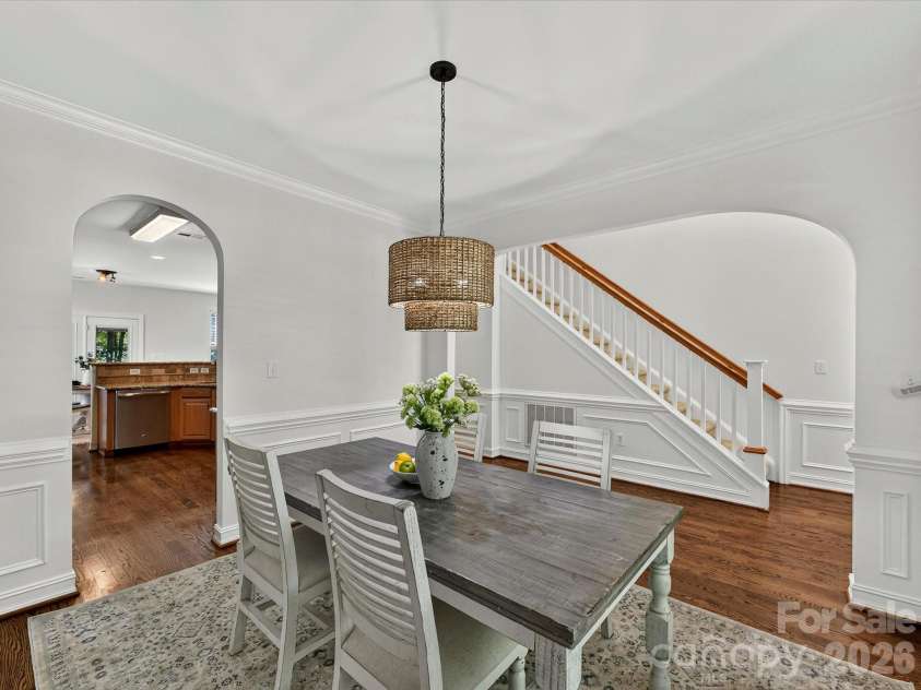 18814 Coachmans Trace, Cornelius, NC 28031.  MLS# CAR4399708, YatesRealty ID 37607. Elegant wainscoting, crown molding, and a designer light fixture create a warm and inviting formal dining room perfect for hosting family and friends.