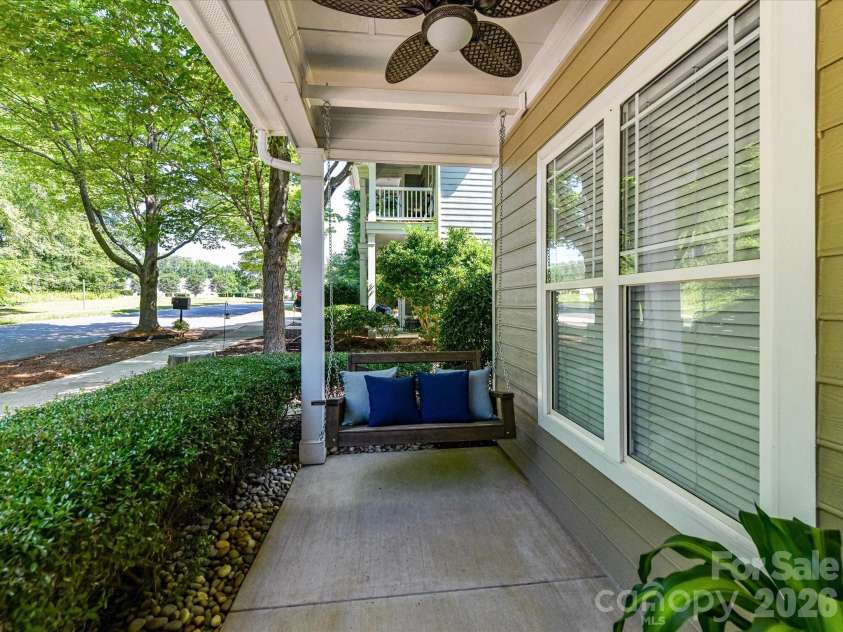 18814 Coachmans Trace, Cornelius, NC 28031.  MLS# CAR4399708, YatesRealty ID 37607. Relax year-round on the charming covered front porch complete with a porch swing, ceiling fan, and peaceful neighborhood views.