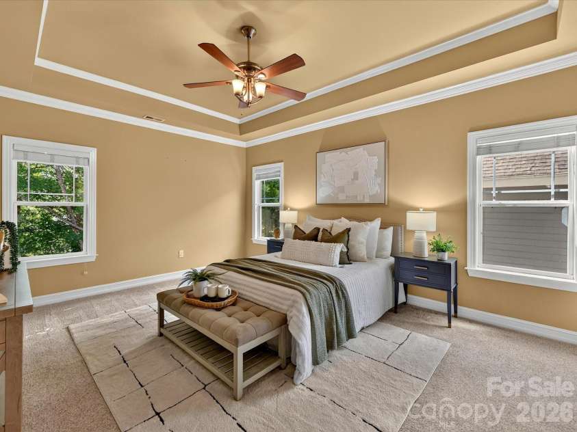 18814 Coachmans Trace, Cornelius, NC 28031.  MLS# CAR4399708, YatesRealty ID 37607. Retreat to the spacious primary suite on the upper level featuring a tray ceiling, abundant natural light, and plenty of room for a private sitting area.