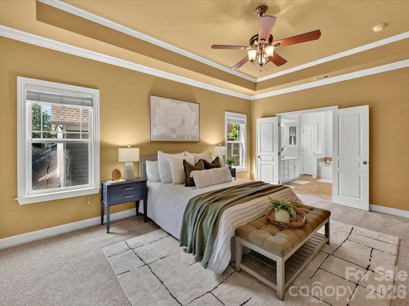 18814 Coachmans Trace, Cornelius, NC 28031.  MLS# CAR4399708, YatesRealty ID 37607. Retreat to the spacious primary suite on the upper level featuring a tray ceiling, abundant natural light, and plenty of room for a private sitting area.