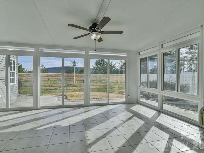 4 Heather Way, Candler, NC 28715.  MLS# CAR4355118, YatesRealty ID 3761. Glass enclosed patio with HVAC.