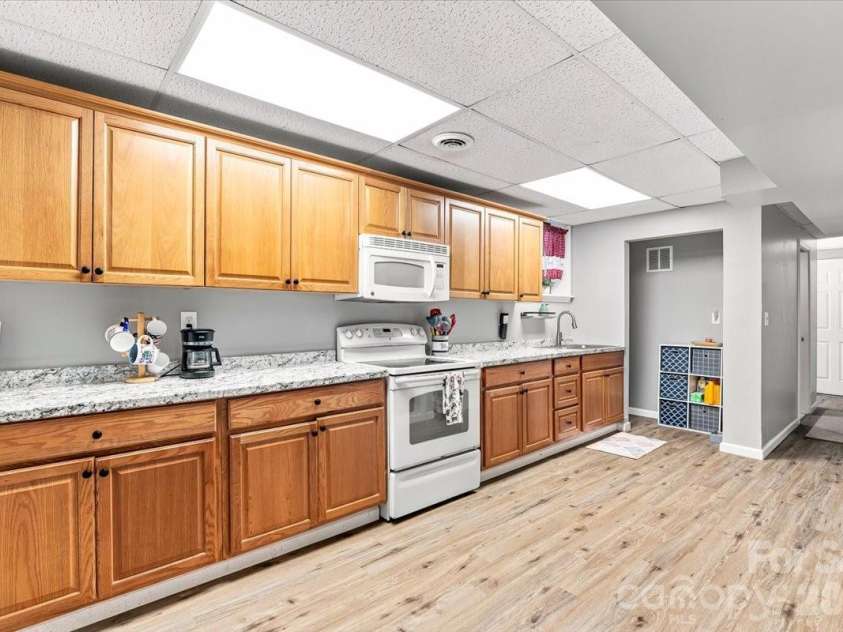 216 Dundeve Circle, Hendersonville, NC 28792.  MLS# CAR4403940, YatesRealty ID 37633. Basement kitchen