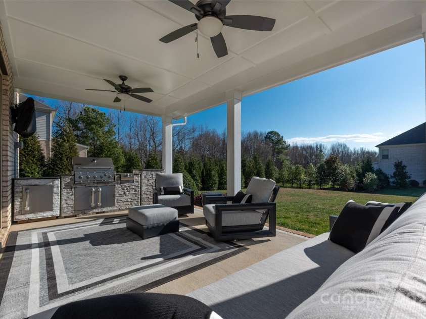 105 Downton Abbey Drive, Marvin, NC 28173.  MLS# CAR4332508, YatesRealty ID 3764. Covered patio overlooks the almost 1/2 acrea level yard.