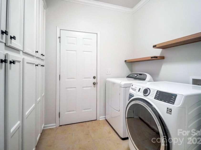 1126 Snowbird Lane, Waxhaw, NC 28173.  MLS# CAR4222147, YatesRealty ID 3767. Laundry room with abundant storage cabinets.