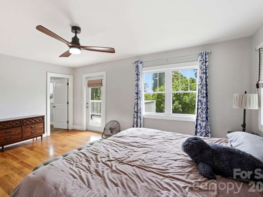 26 Crestwood Drive, Arden, NC 28704.  MLS# CAR4400337, YatesRealty ID 37672. Primary Bedroom with door to the upper deck