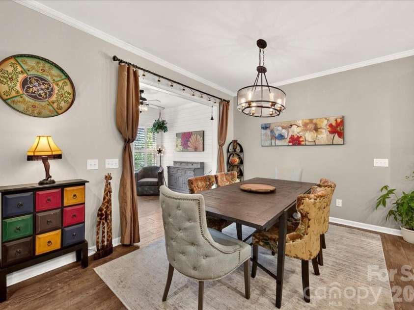 3093 Hartson Pointe Drive, Fort Mill, SC 29707.  MLS# CAR4402189, YatesRealty ID 37679. Dining room sunroom opens to large covered deck overlooking tree lined backyard